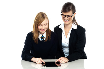 Image showing Educator and student exploring a tablet device