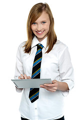 Image showing Cheerful student in school attire using tablet pc