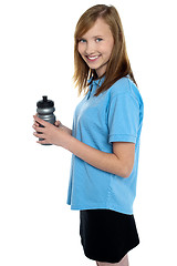 Image showing Girl holding sipper bottle. Break from gym workout