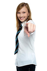 Image showing Cheerful young girl pointing towards the camera