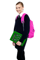 Image showing School girl posing with backpack and calculator