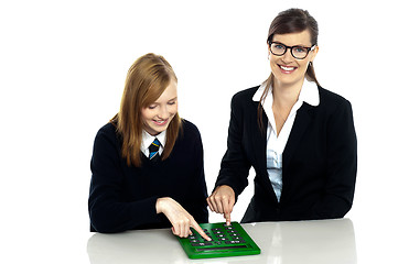 Image showing Teacher and student working on calculator