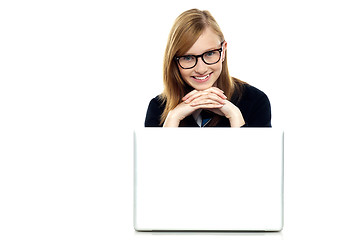 Image showing Charming schoolgirl sitting with her laptop open