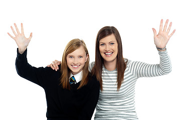 Image showing Mum and daughter waving hands at the camera