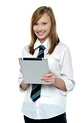 Image showing Gorgeous teenager browsing on her tablet pc