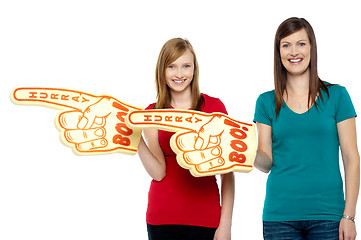 Image showing Cheerful fans pointing the big foam hand sideways