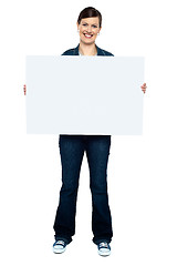 Image showing Fashionable trendy woman holding blank ad board