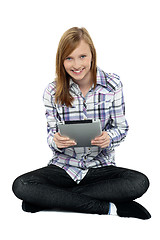 Image showing Smartly dressed teenager surfing on tablet pc