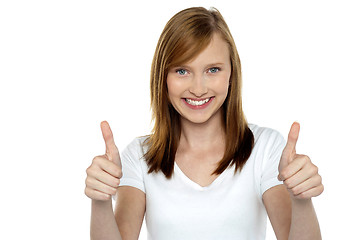 Image showing Pretty teenager gesturing double thumbs up