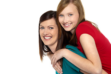 Image showing Mother giving daughter ride on back