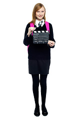 Image showing Cute school girl with a clapperboard