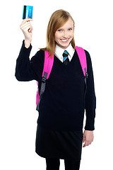 Image showing Teen girl in uniform holding up a cash card