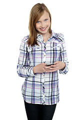 Image showing Casual teen girl messaging her friends