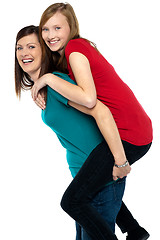 Image showing Happy mother giving piggyback ride to her daughter