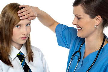 Image showing Doctor placing her hand on a patients forehead