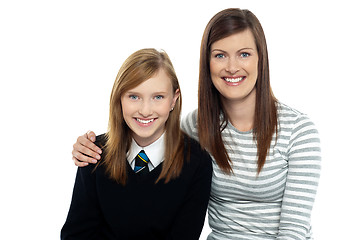 Image showing Mom posing with arms around her cute daughter