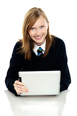 Image showing Pretty schoolgirl holding newly launched tablet pc