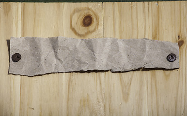 Image showing Grey paper attached by rusty push pins