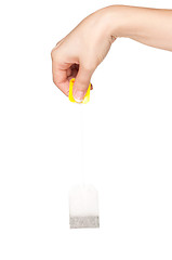 Image showing Hand with teabag