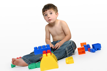 Image showing Young boy amongst building blocks