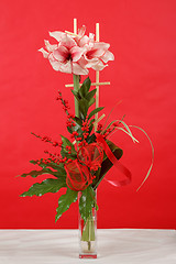 Image showing bouquet of pink lily flower on red