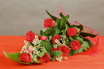 Image showing Bouquet of fresh red roses on gray