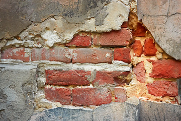 Image showing Old brick wall with destroyed stucco