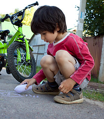 Image showing boy  drawing with chalk on asphalt