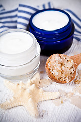 Image showing face cream in jars with sea salt and star 