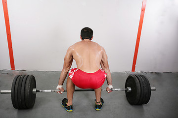 Image showing Man makes exercises for increase in force of muscles.  Focus in 