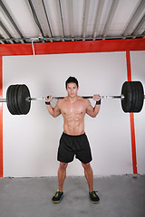 Image showing Man with dumbbell weight training equipment on sport gym