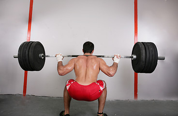 Image showing The concept of power and determination of a man lifting a weight