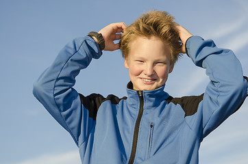 Image showing Kid adjusts his hair