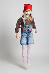 Image showing Happy young girl wearing Christmas elf hat jumping