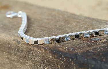 Image showing Silver bracelet on a piece of wood