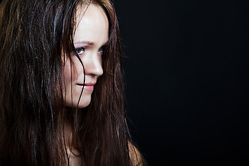Image showing beautiful girl with long wet hair on a black background