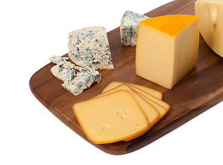 Image showing Different types of cheese on wooden kitchen board