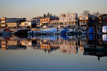 Image showing Reflection of coastline buildings in a calm bay