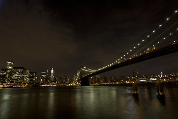 Image showing Brooklyn Bridge and Manhattan skyline At Night