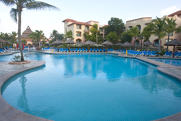 Image showing Beautiful pool and patio in tropical setting 