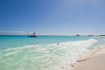 Image showing Waves splash onto golden shore 