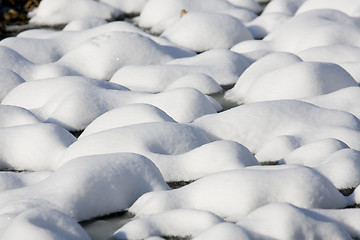 Image showing Bumpy lawn covered with snow