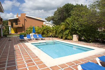 Image showing Beautiful pool and patio in tropical setting 