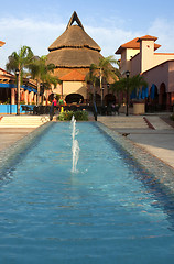 Image showing Beautiful pool and patio in tropical setting 