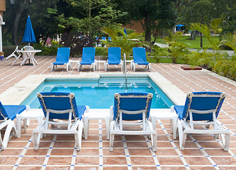 Image showing Beautiful pool and patio in tropical setting 