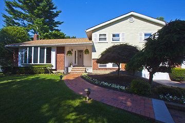 Image showing Luxury family house with landscaping on the front and blue sky o