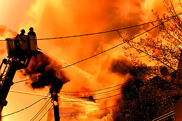 Image showing a huge fire with firefighters in action 