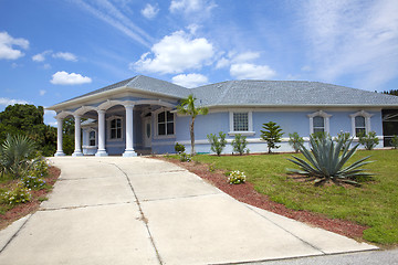 Image showing Luxury family house with landscaping on the front and blue sky o