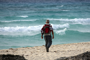 Image showing Man walking on the beach in the morning.