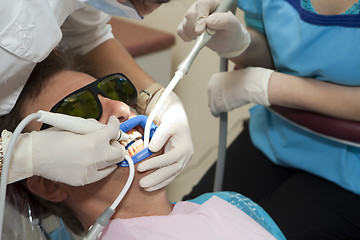 Image showing Visit to the dentist. Dentist at work in dental room